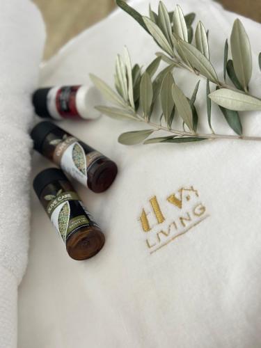 two bottles of wine on a towel with a plant at Sunset Gardens - Holiday Apartments - by TLV Living in Limassol
