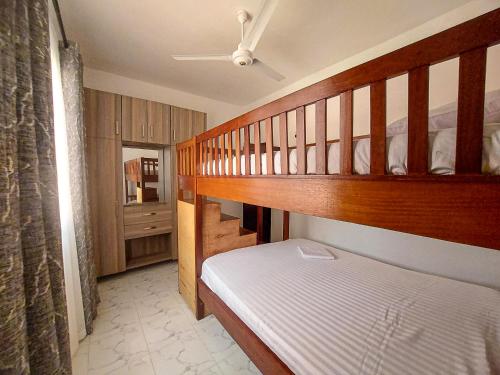 a small bedroom with a bunk bed and a staircase at Jamiitown Homes in Kilifi