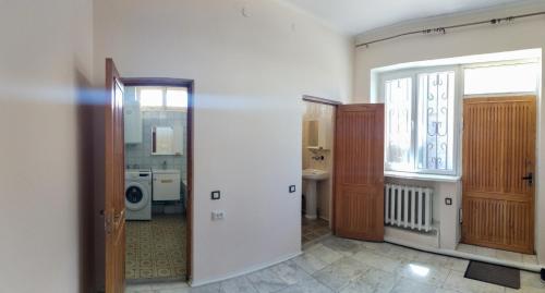 a room with a bathroom with a sink and a washing machine at GUEST HOUSE SG in Norakert