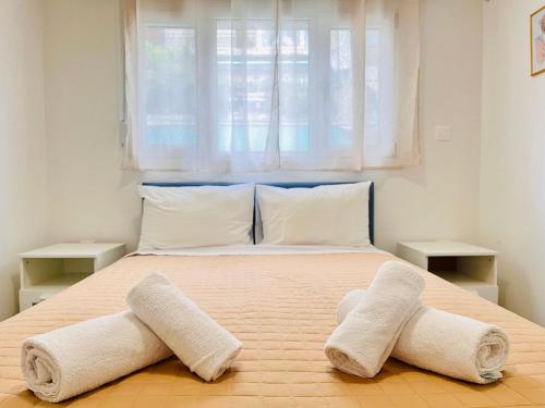 a bedroom with a bed with two towels on it at Elvita Apartments 4 in Athens