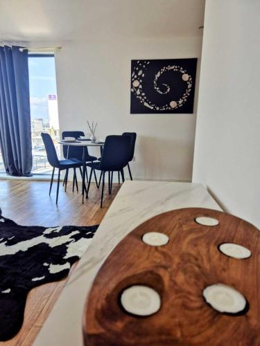a bedroom with a table and chairs in a room at Manchester Penthouse - 2 Bedroom Apartment in Manchester