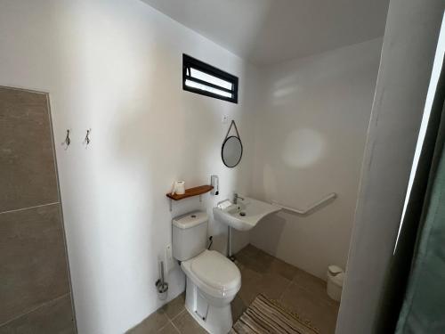 a bathroom with a toilet and a sink at MOOREA CHILL and BEACH LODGE in Teavaro