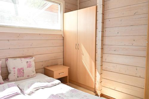 クライペダにあるGirulių poilsiavietės namelis - IXのベッドと窓のある小さな寝室