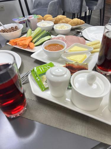 a table with a plate of food on a table at Mashtots Hotel in Yerevan
