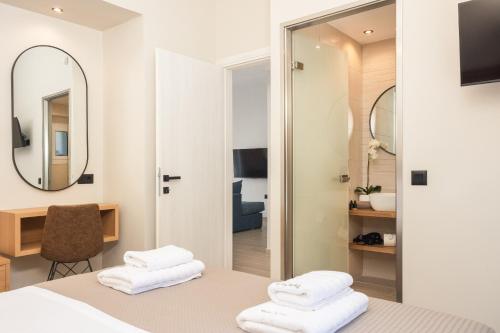 a hotel room with a bed and a mirror at Porta Verde Luxury Residence, By TK Property Management in Laganas