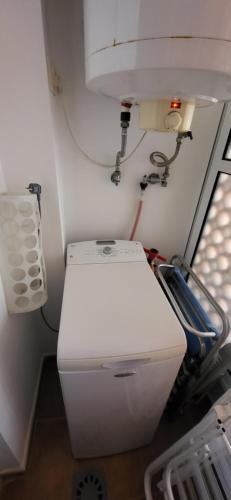 a bathroom with a white toilet in a room at Apartamento Las Dunas de Isla Canela in Isla Canela