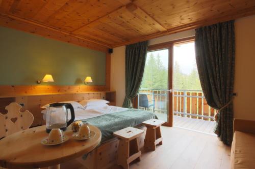 una camera con letto e balcone di Ciasa Vervei a Cortina dʼAmpezzo