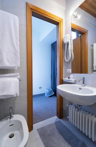 a bathroom with a white sink and a mirror at Albergo Sorriso in Boario Terme