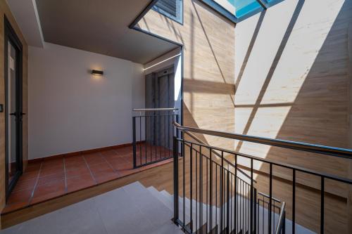 a staircase in a house with a glass ceiling at Limehome Barcelona Plaça Pirineus in Hospitalet de Llobregat