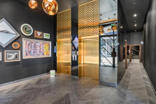 a hallway of a building with paintings on the walls at Greenhouse Apartments by Urban Rest in Auckland