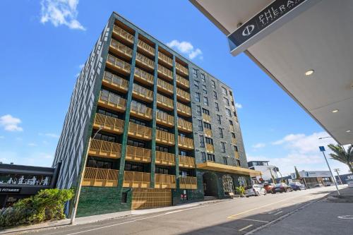 a tall building on a city street at Greenhouse Apartments by Urban Rest in Auckland