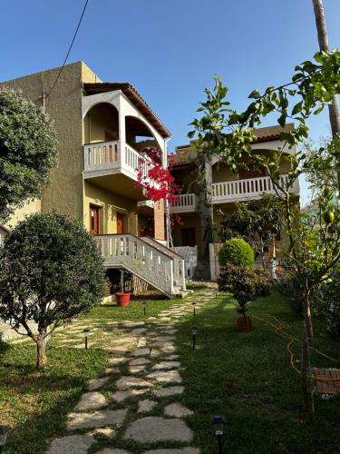 a large house with a walkway in front of it at Nicolas Beach in Palaiochora