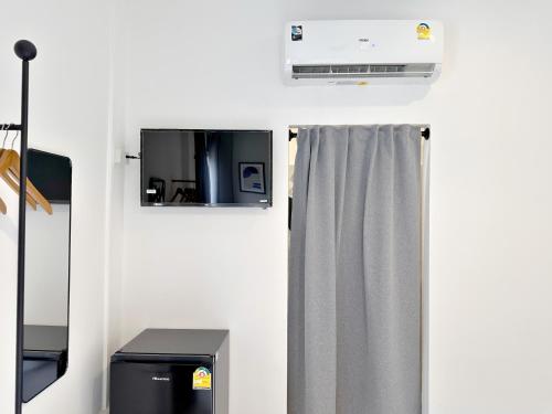 a room with a heater and a shower curtain at Na Ekkamai Residence in Bangkok