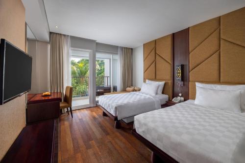 Postel nebo postele na pokoji v ubytování Sanur Resort Watujimbar