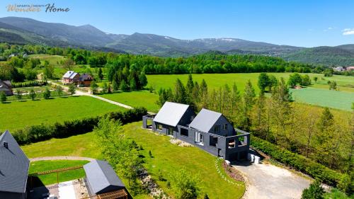 an aerial view of a house on a green field at Wonder Home - Luksusowy dom Casa Moderna z dwoma tarasami w cichej okolicy blisko Karpacza in Kowary