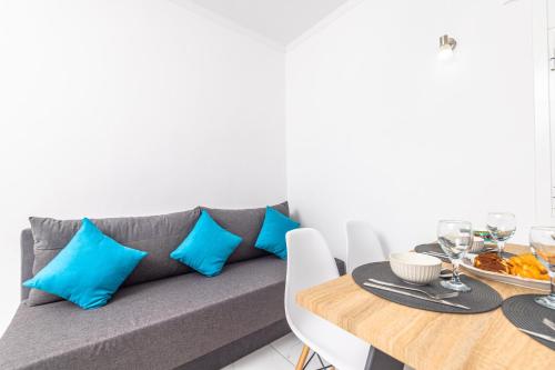 a living room with a couch with blue pillows at Soso's Garden House with Pool in Plános