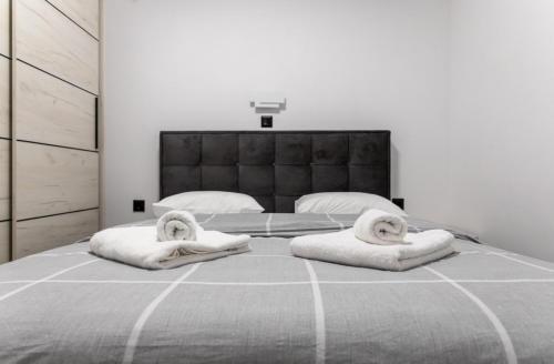 a bedroom with a large bed with towels on it at Exclusive ladadika apartment 1 in Thessaloniki