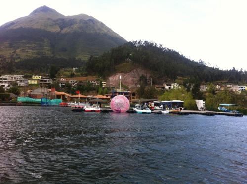 a group of boats in a body of water with a mountain at Casa Campestre en una comunidad tradicional en la naturaleza 1 in San Juan de Ilumán