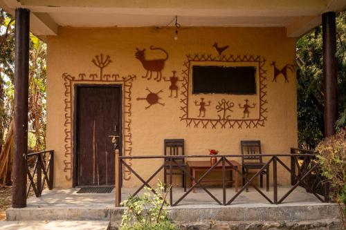 a house with a painting on the side of it at Bardia Riverside View Park Resort in Bhurkīā