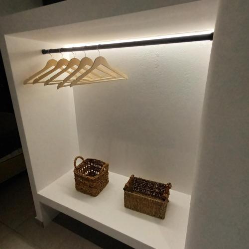 two baskets on a shelf in a display case at Maison Kalogiannis in Patitiri