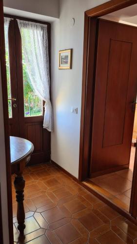 a room with a door and a table and a window at La Terrazza sul Mare Sea View - near best beaches in Monterosso al Mare