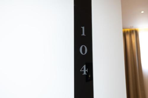 a close up of a elevator sign in a room at Hotel Aluor in Vlorë