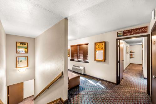 a hallway with a hallway leading to a room at Americas Best Value Inn Marquette in Marquette
