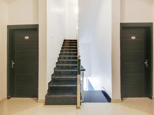 a staircase in a building with two doors at The Nines Hotel & Restro in Kālādhūngi