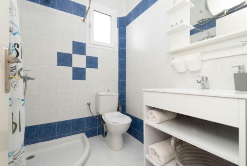 a bathroom with a toilet and a sink at Dora's Apartments in Laganas