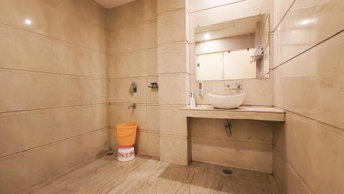 a bathroom with a sink and a mirror at Hotel Sallow Royal Suites in Amritsar