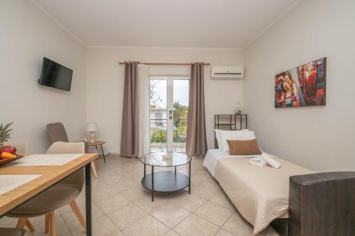 a living room with a couch and a table at Dora's Apartments in Laganas