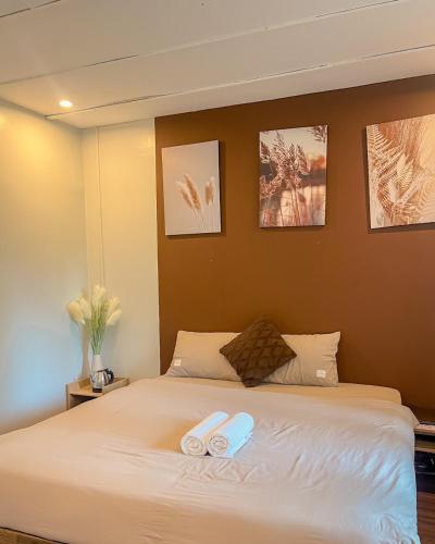 a bedroom with a bed with two towels on it at Love House Homestay SAPA in Sa Pa