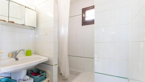 une salle de bain blanche avec un lavabo et une douche dans l'établissement IPANEMA - 181 - Studio Mezzanine 4-6 pers, au Cap d'Agde