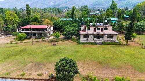 an aerial view of a large house in a field at Hideaway By Aahma in Rāmnagar