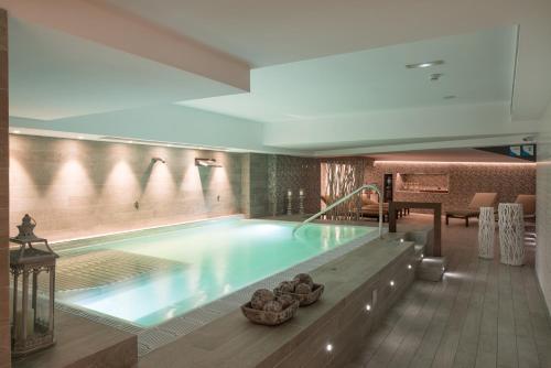 a large swimming pool in a hotel lobby at Catalonia Atenas in Barcelona