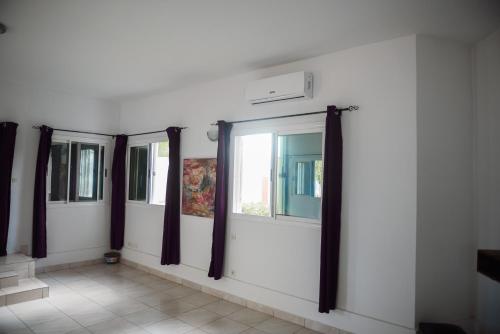 a row of windows on a white wall at Maison Stella Lome in Lomé