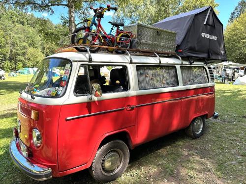 a red and white van with a bike on the top at ECO River Camp - Pitches in Radovljica