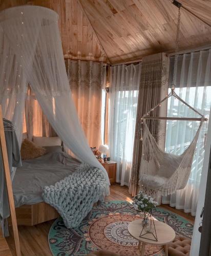 a bedroom with a bed with a hammock in it at Love House Homestay SAPA in Sa Pa