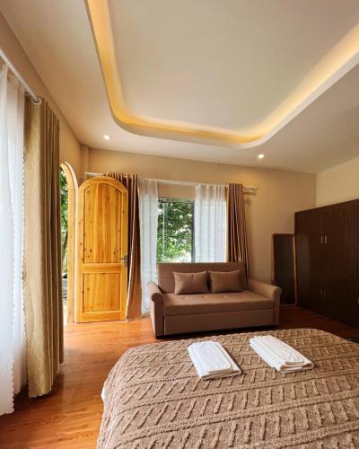 a living room with a bed and a couch at Love House Homestay SAPA in Sa Pa