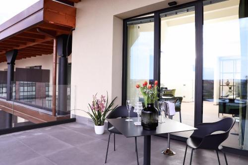 a dining room with a table and chairs on a balcony at Hotel Veronesi La Torre in Dossobuono