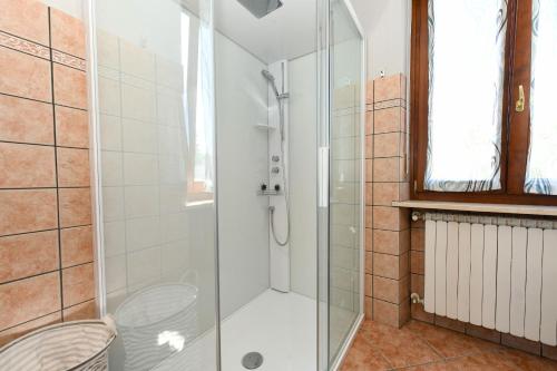 a shower with a glass door in a bathroom at La Vela Deluxe in Salò