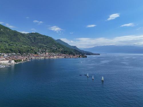 a group of sailboats in a large body of water at La Vela Deluxe in Salò