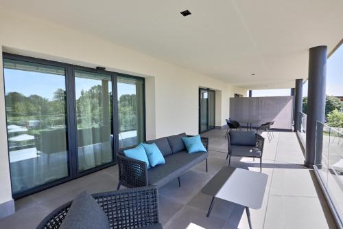 a living room with a couch and chairs on a balcony at Hotel Veronesi La Torre in Dossobuono