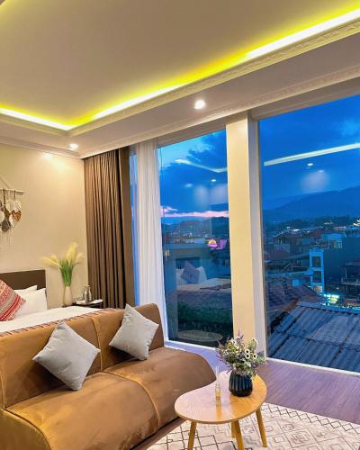 a living room with a couch and a large window at Love House Homestay SAPA in Sa Pa