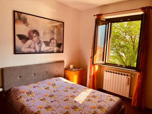 a bedroom with a bed and a large window at Incanto Nesso Parking and Lake View in Nesso