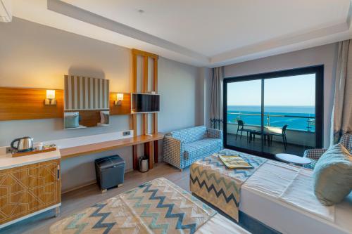 a hotel room with a bed and a view of the ocean at Lonicera Premium - Ultra All Inclusive in Avsallar