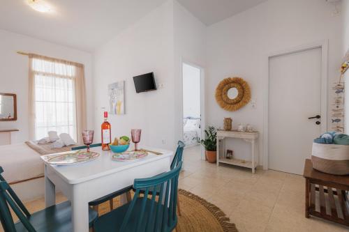 a kitchen and living room with a table and chairs at Studios Eliza in Livadi