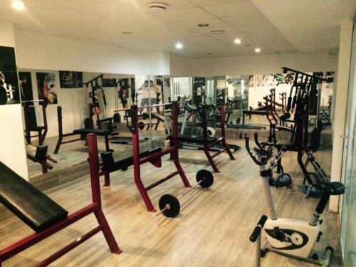 a gym with several treadmills and exercise bikes at AQUA CİTY SUİT in Antalya