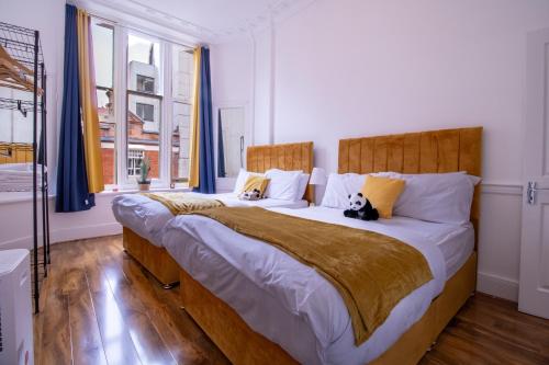 twee katten zittend op een groot bed in een slaapkamer bij Selfridges Skyline Suite Located Next to Bond Street in Londen