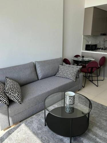 a living room with a couch and a table at Exclusive 2BR With City View in Dubai